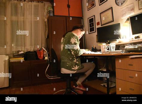 green sweater desk behind.